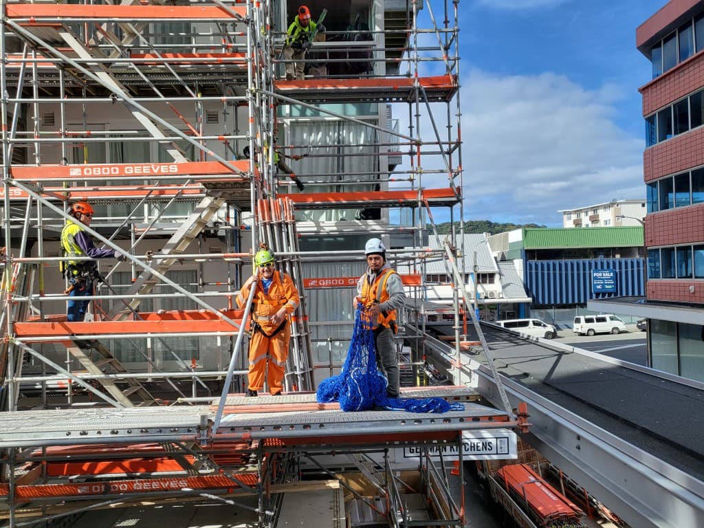 Aotea Solutions team in hi-vis on scaffolding at a Wellington commercial construction site